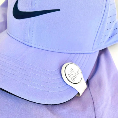 Purple Nike cap with a White fold-over magnetic golf ball marker by Golf Garter.