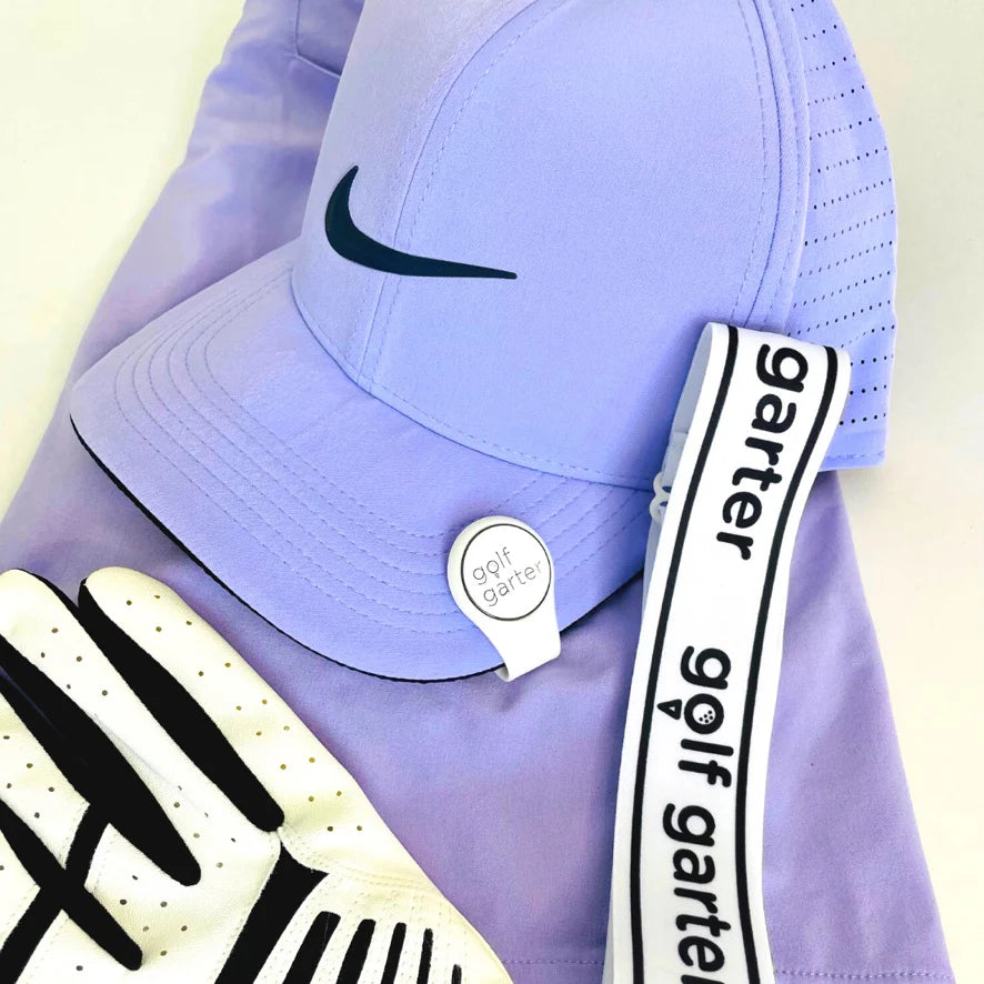 Purple Nike cap with a White fold-over magnetic golf ball marker and a Golf Garter accessory for women golfers.